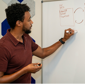 DSA volunteer writing on a whiteboard
